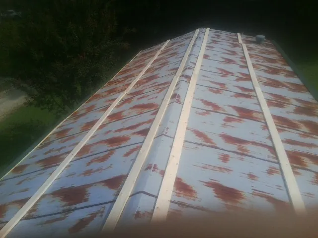 Rusted metal roof panels with new wood purlins before replacement — Storm Damage Roof Repair in Partlow by Roofing Brothers