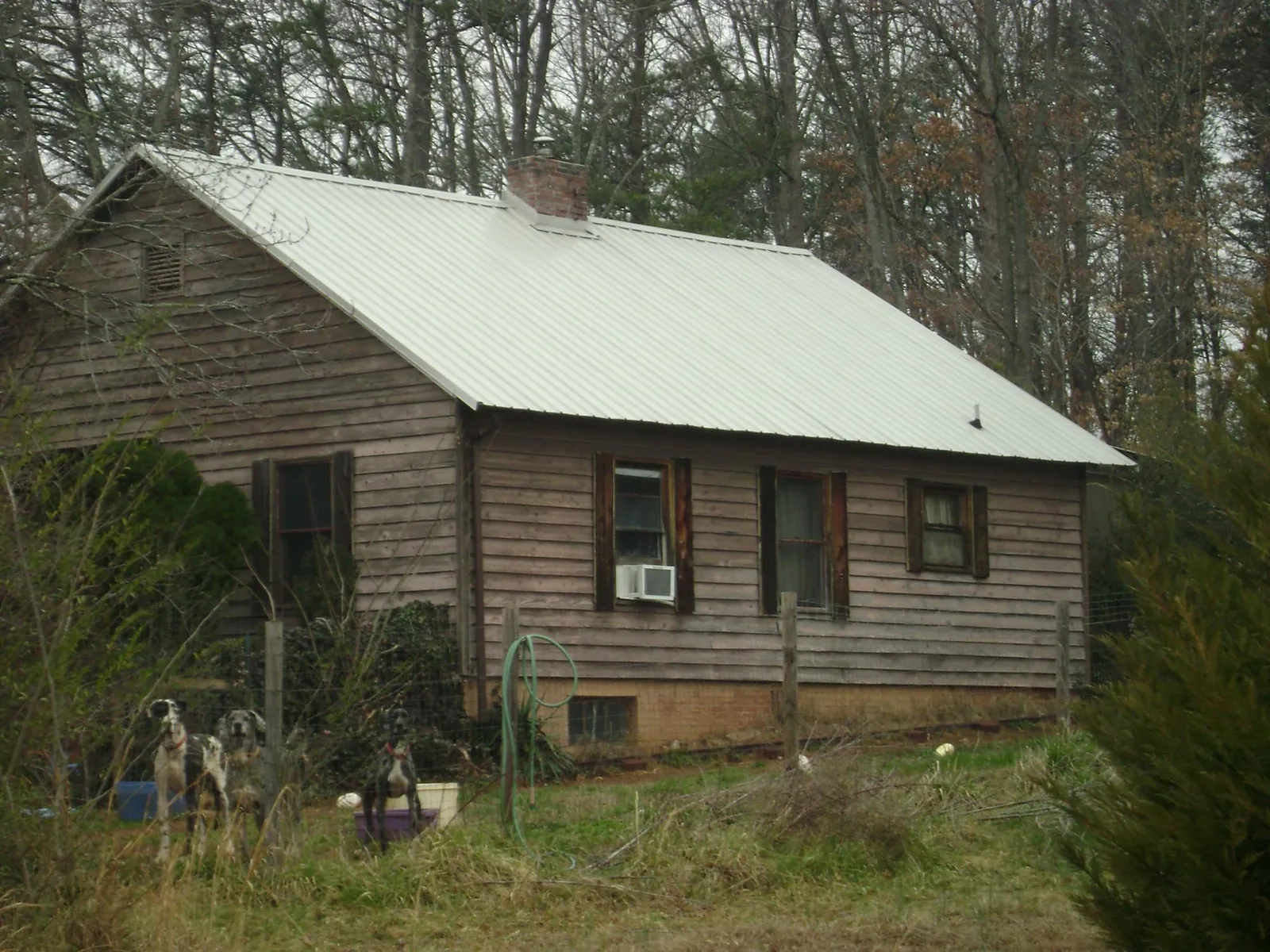 White metal roof on an old wood sided farmhouse, from a Metal Roof Installation job in Partlow